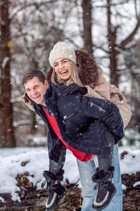 爱快乐的年轻夫妇在冬季公园有乐趣