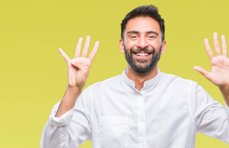 成年西班牙裔男子在孤立的背景显示和指向手指数九, 而微笑着自信和快乐