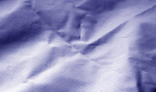 皱巴巴的纺织品表面在蓝色口气。设计的抽象背景和纹理
