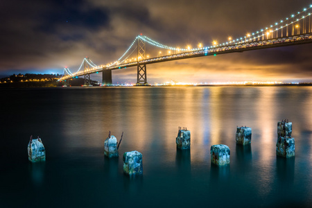 桥墩桩和 San Francisco奥克兰湾大桥夜景