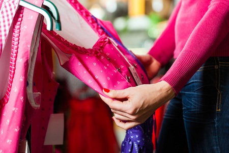 女人购买 tracht 或在一家商店的裙照片
