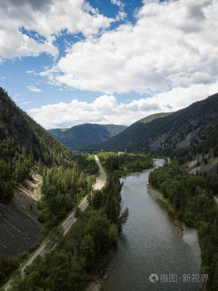 鸟瞰一条风景秀丽的公路, 穿过山谷, 四周是美丽的加拿大山脉.