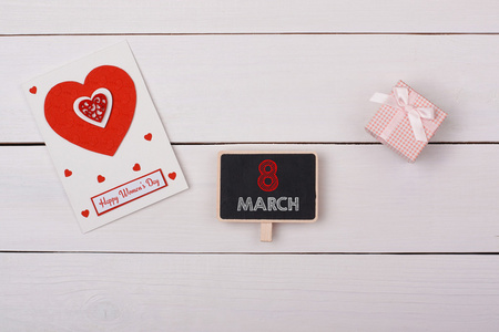 黑板上用 3 月 8 日标记 礼物和一张卡片，用红色的心