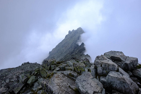 在斯洛伐克塔特拉山脉的岩石尖锐的山峰, 云层和薄雾从上面和雨云。Rysy 山