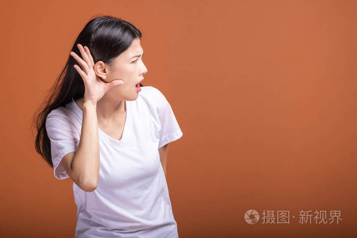 女人试图听到的姿势亚洲妇女白色t恤衫