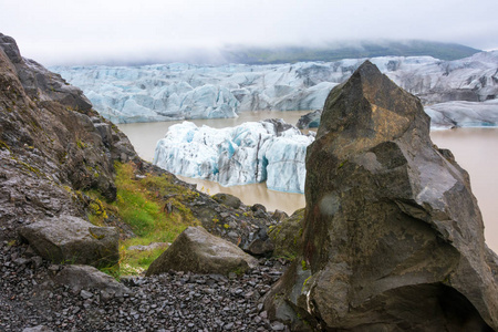 蓝色冰在暗藏的 Svinafellsjokull 冰川泻湖在巨大的 Vatnajokull 冰川的胳膊在南冰岛