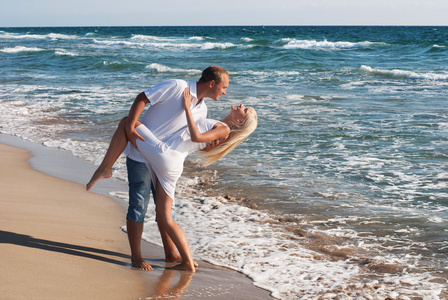 在夏天的海海滩上跳舞的恩爱夫妻