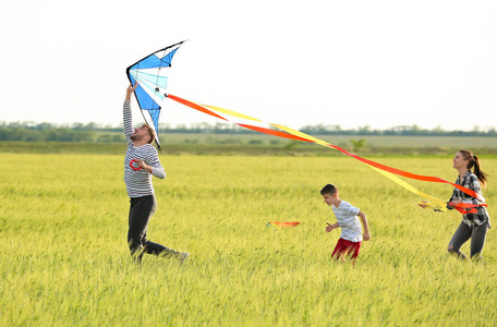 快乐的家庭在野外放飞风筝图片