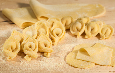 意大利的自制意大利饺子和生面团放在撒了面粉的一张小木桌