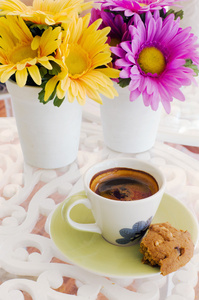 陶瓷杯咖啡，黄色和紫色的花