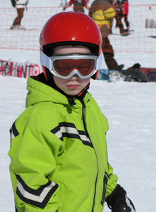 儿童上滑雪板和头盔