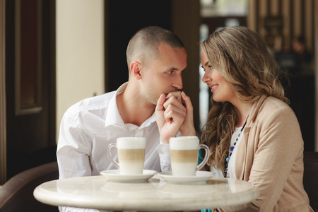 Happy couple drinking coffee in an urban caf.