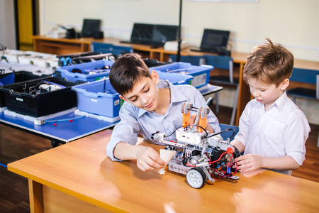 两个兄弟孩子玩机器人玩具在学校机器人类, 室内