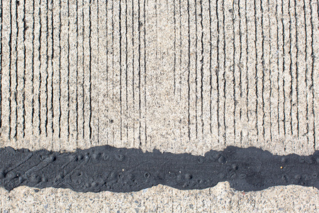 黑色的沥青，与水泥背景