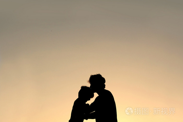 轮廓的额头上亲吻年轻孩子的父亲