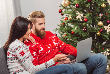 夫妇在圣诞节使用笔记本电脑