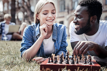 高兴周到的女人看着棋盘