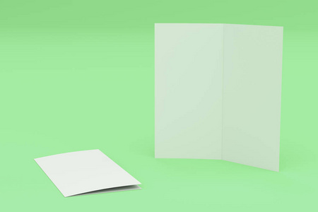 空白的白色两折小册子样机在绿色背景上