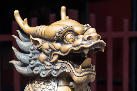 青铜龙头雕刻在入口处的一座佛教寺庙照片