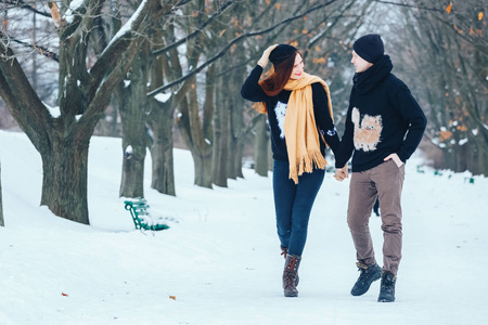 微笑对夫妇一起在白雪皑皑的树林里散步
