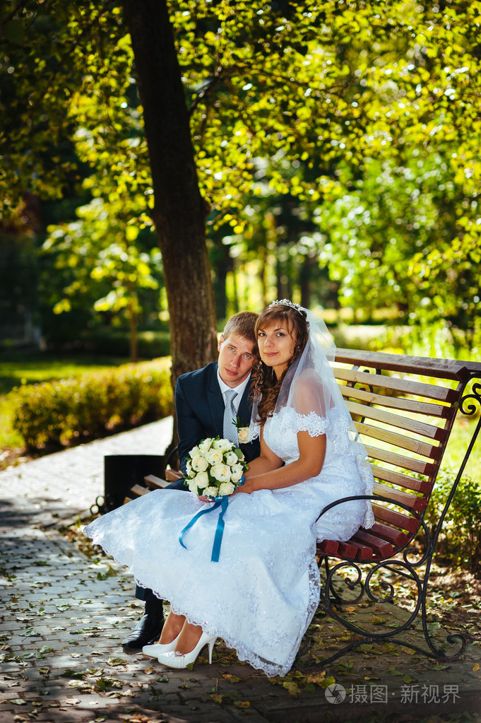 新婚夫妇,幸福的新婚夫妇在绿色公园深情相拥