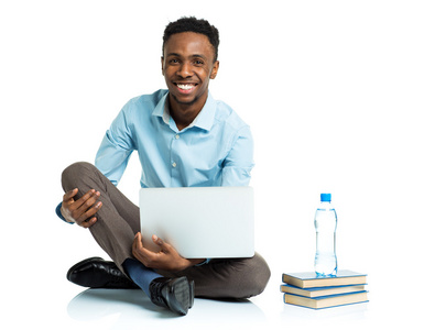 快乐的非洲裔美国大学生与笔记本电脑，书坐