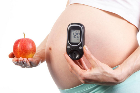 孕妇血糖仪和新鲜的苹果，在怀孕期间的健康营养的概念