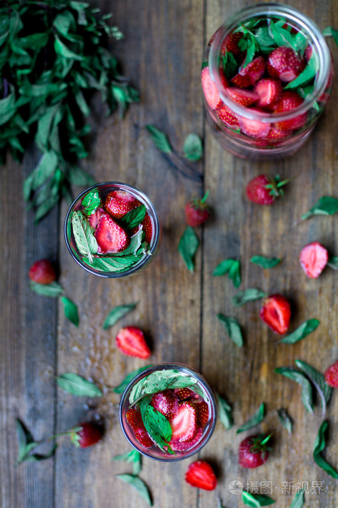 草莓薄荷注入水在黑色的木桌子背景下的乡村风格的装饰