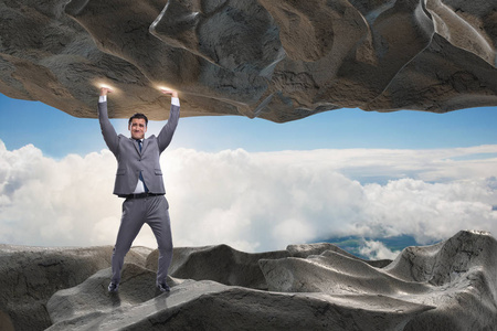 支持在压力下的石头的商人照片