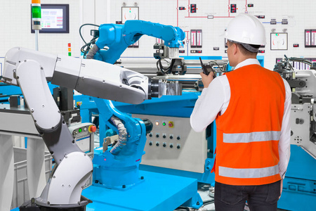 维修工程师控制自动机器人手机床工业制造工厂，所属 4.0 概念