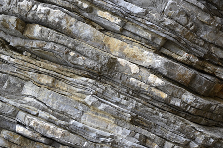 花岗岩悬崖石头的岩石和悬崖背景照片