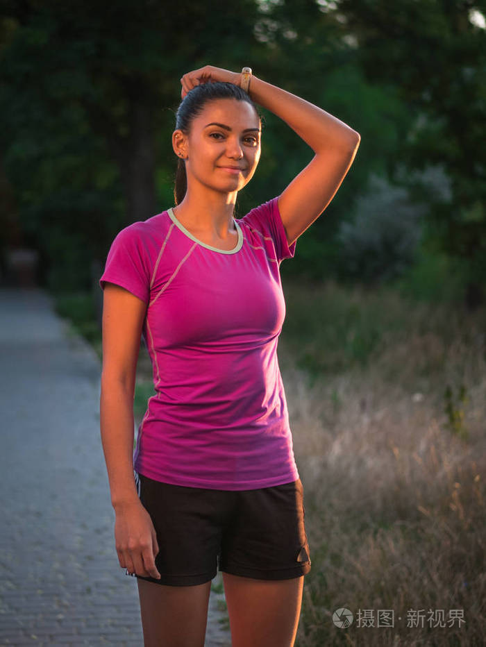 在公园中轻松的快乐运动女人的侧面肖像.