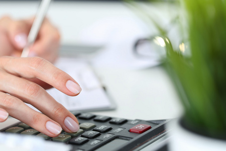 计算器手在计算器上工作的手照片