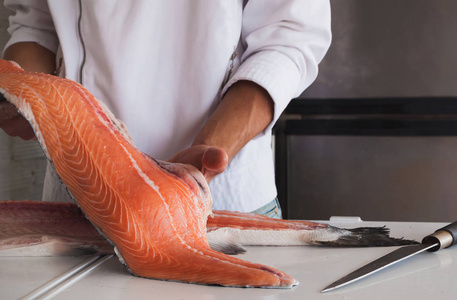 厨师拿着新鲜的鲑鱼片照片