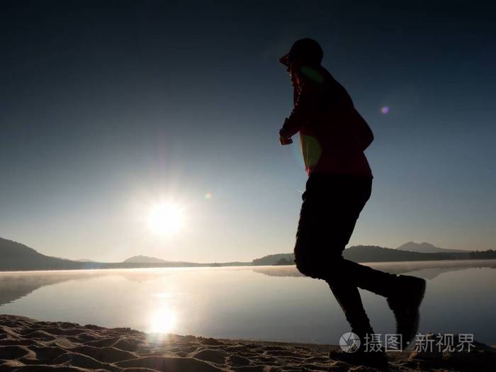 男孩很快跑在早晨的海滩上.运动员跑步,跑步的家伙