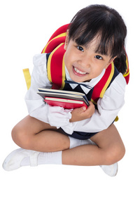 亚洲中国小学女孩坐在地板上照片