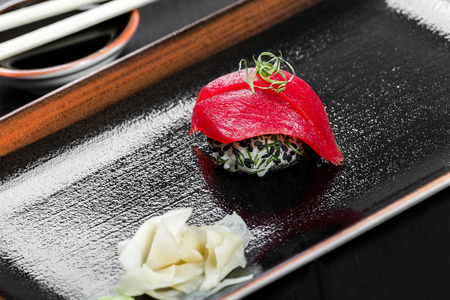 与黑暗的木制背景上金枪鱼饭。京坎寿司套。日本料理。顶视图