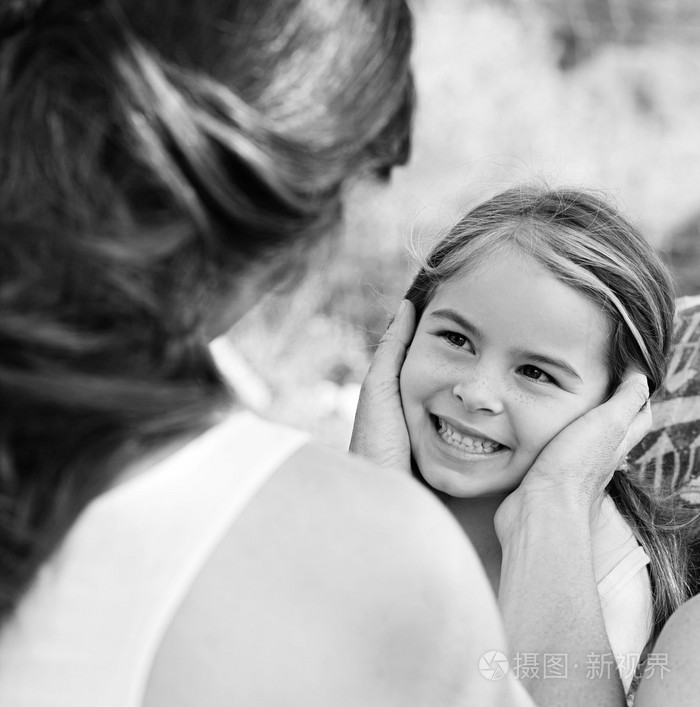 母亲双手捧着女儿的脸