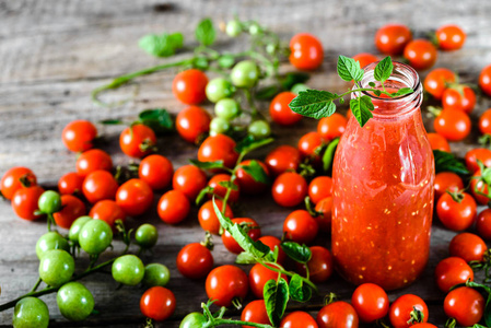 瓶番茄汁和新鲜的西红柿，木制的桌子，健康食品有机饮料概念上