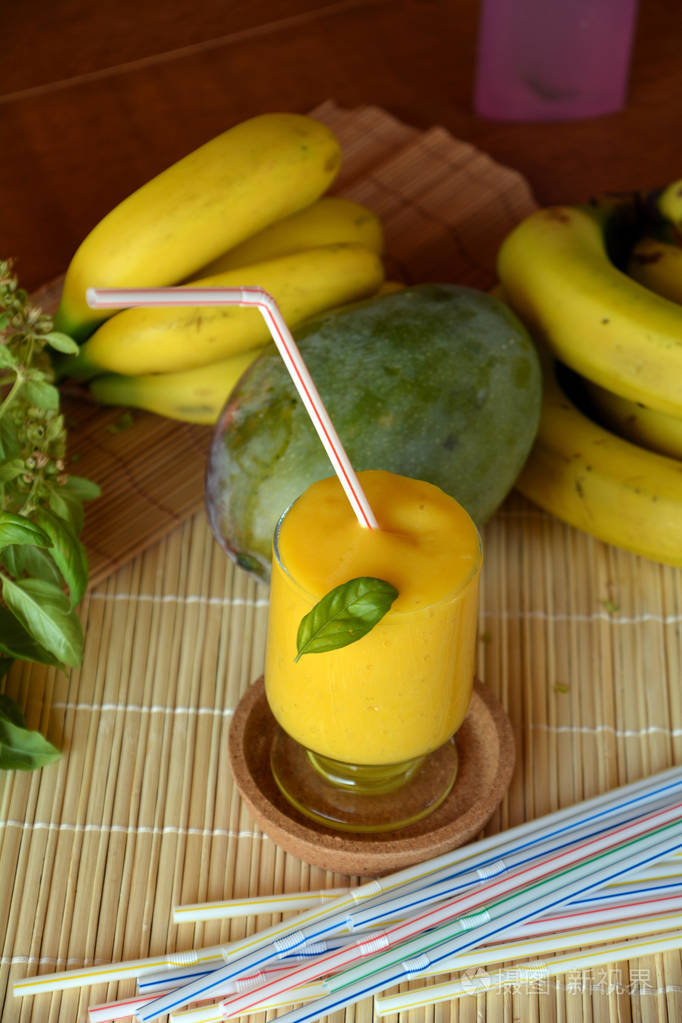 新鲜健康芒果和香蕉奶昔在玻璃上有机饮料