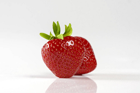 孤立在白色背景上的两个红草莓