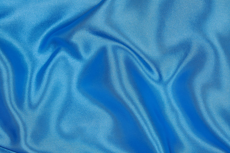 蓝色的丝绸布的波浪抽象背景图片
