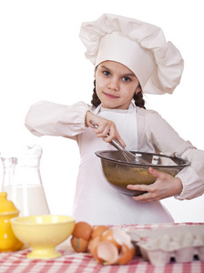 烹饪和人们的观念微笑在厨师的帽子的小女孩