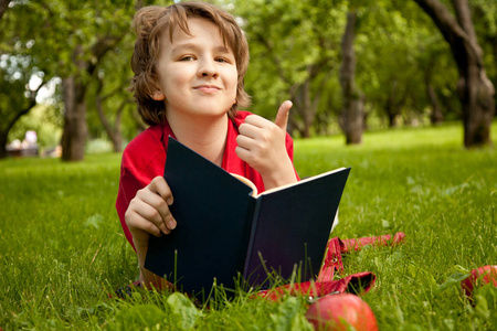 绿色的夏天苹果树木公园里读书的青少年男孩