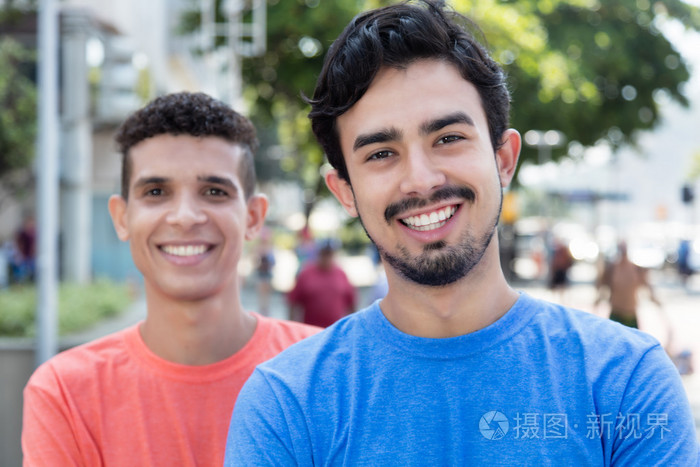 笑着墨西哥的家伙在城市中的朋友