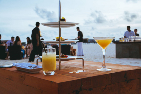 马尔代夫热带岛屿海滩酒吧桌上的鸡尾酒和美味小吃