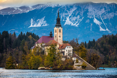 流血, 斯洛文尼亚美丽的秋天日出在湖流血与玛丽亚的假定的著名朝圣教会与流血的城堡和朱利安阿尔卑斯在背景