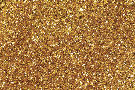 装满了闪闪发光的金色亮片的背景照片