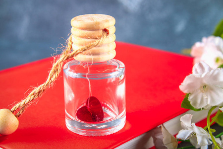 红色的心脏在一个小的玻璃罐子在一个灰色的具体背景。情人节的概念。爱的象征