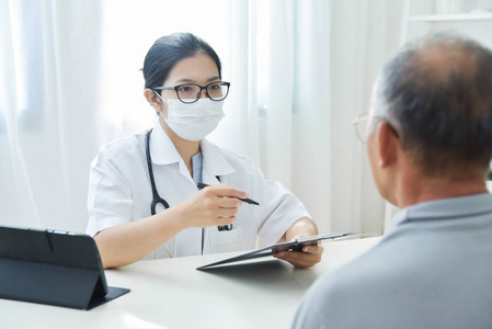亚洲女医生与老年男性患者交谈